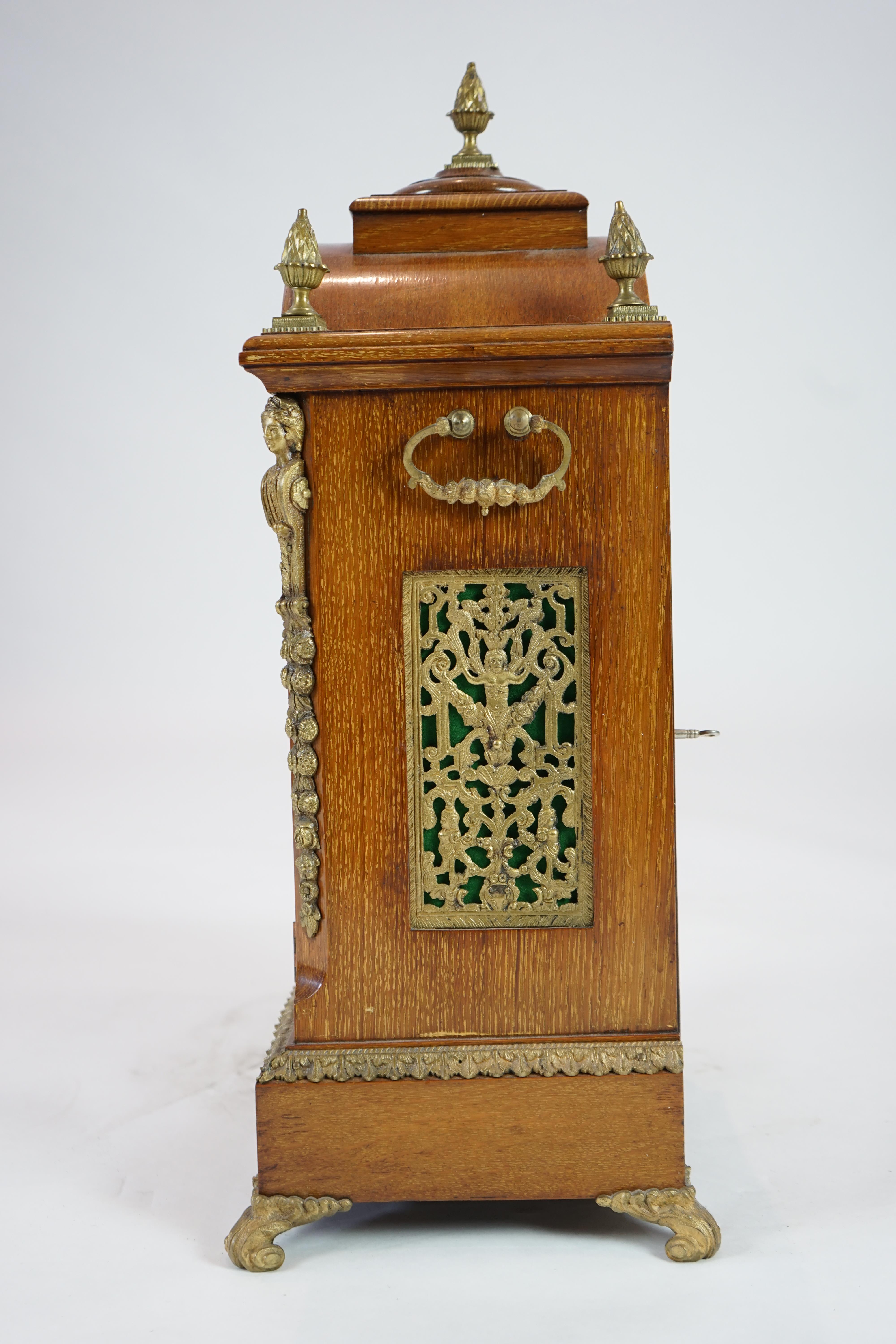 A late Victorian ormolu mounted golden oak cased eight day chiming bracket clock and bracket